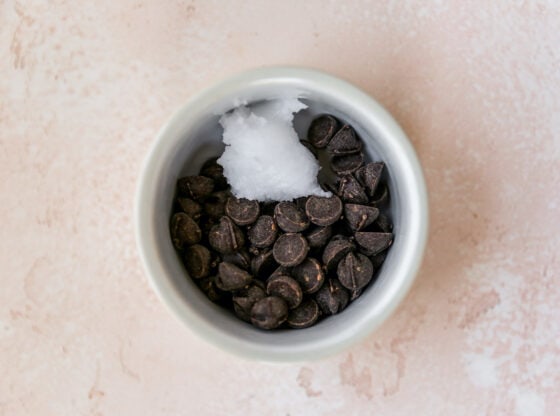 Bowl with dark chocolate chips and coconut oil.