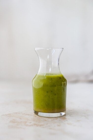 Jar of basil vinaigrette.