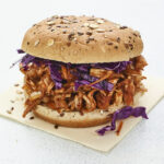 Jackfruit bbq sandwich topped with cabbage.