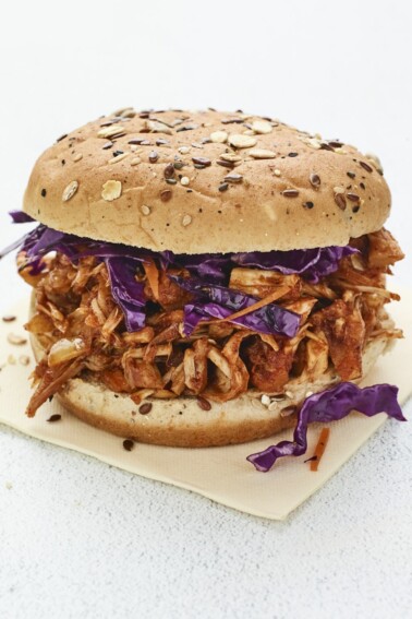 Jackfruit bbq sandwich topped with cabbage.