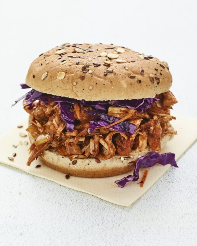 Jackfruit bbq sandwich topped with cabbage.