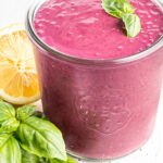 Blueberry weight loss smoothie with basil on top in a glass Weck Jar.