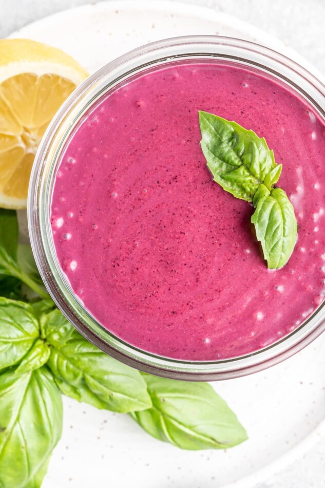 Overhead view of blueberry weight loss smoothie with basil on top in a glass Weck Jar.