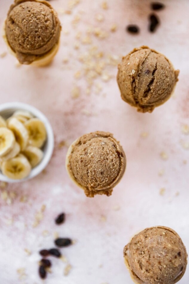 Bird's eye view photo of 4 ice cream cones with scoops of oatmeal raisin ice cream.