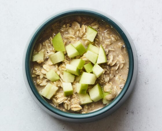 Apple cinnamon baked oatmeal in a bowl before being baked.