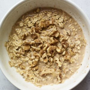 Mixing bowl with mixture to make banana walnut baked oatmeal.