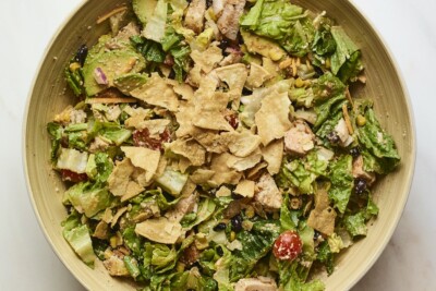 BBQ chicken salad topped with crushed tortilla chips.