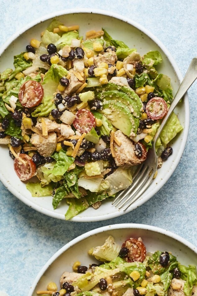 Plated bbq chicken salad with a fork on the side of the plate.