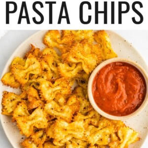 Pasta chips on a plate with a small bowl of marinara for dipping.