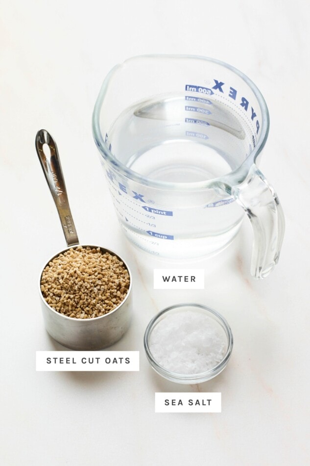 Water, steel cut oats and salt measured out in containers or cups.