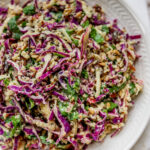 Apple slaw plated on a white plate.