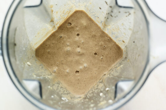 Overhead shot of coffee protein shake blended in a blender.