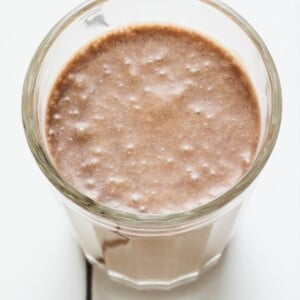 A glass cup with coffee protein shake.