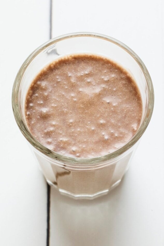 A glass cup with coffee protein shake.