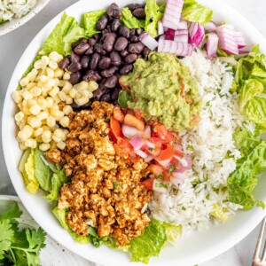 Burrito bowl made with sofritas, black beans, corn, salsa, guacamole, rice, lettuce and romaine.