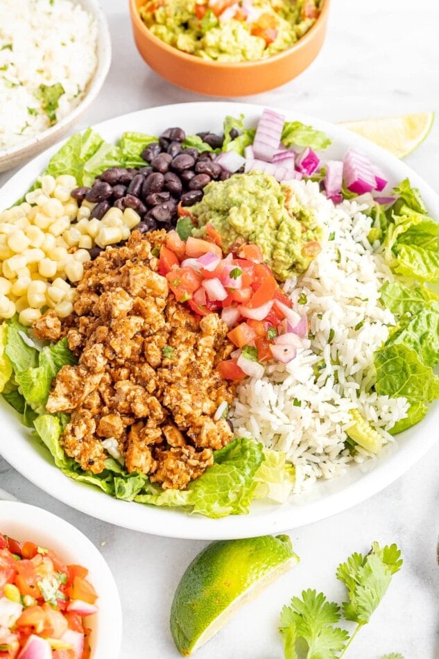 Burrito bowl made with sofritas, black beans, corn, salsa, guacamole, rice, lettuce and romaine.