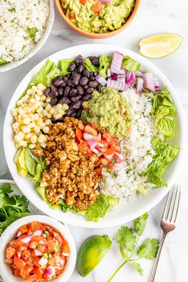 Burrito bowl made with sofritas, black beans, corn, salsa, guacamole, rice, lettuce and romaine.