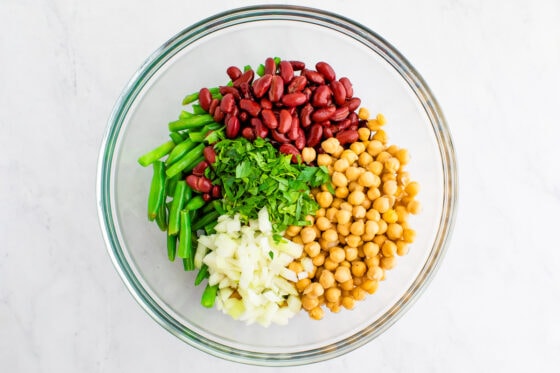 Three bean salad ingredients in a mixing bowl.