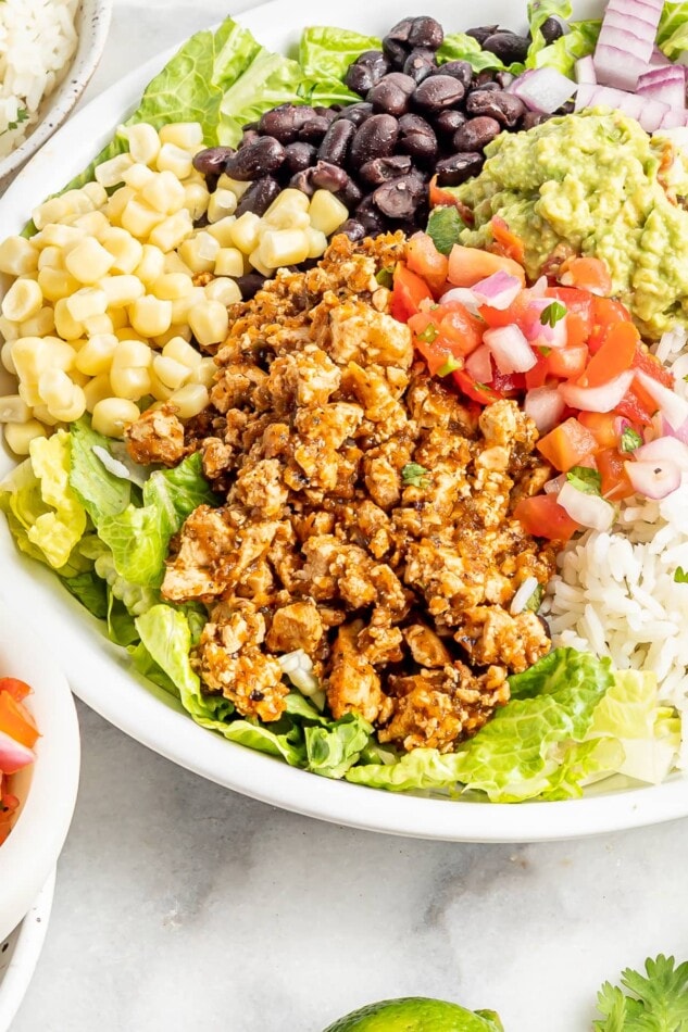 Burrito bowl made with sofritas, black beans, corn, salsa, guacamole, rice, lettuce and romaine.