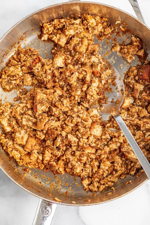 Sofritas in a skillet with a spoon.