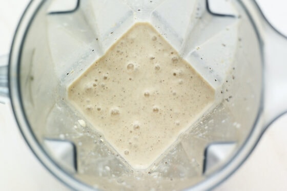 Blended vanilla protein shake in a blender.