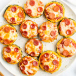 Zucchini pepperoni pizza bites on a plate.