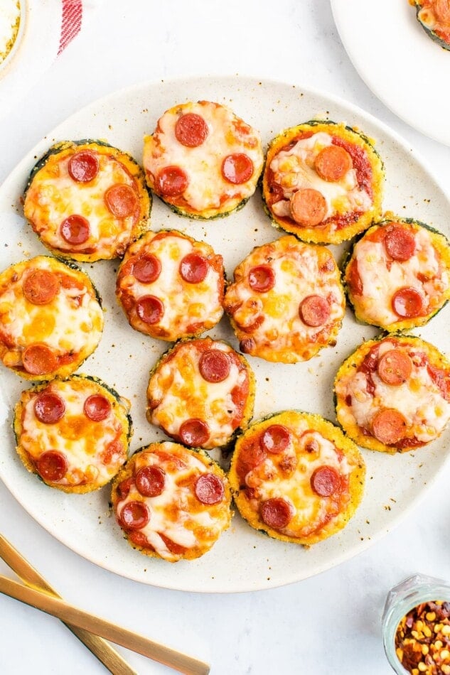 Zucchini pepperoni pizza bites on a plate.