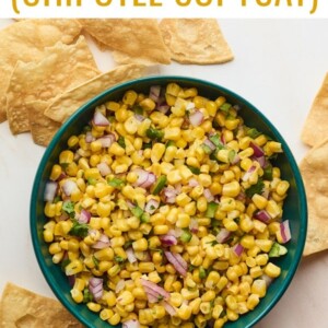 Bowl of corn salsa surrounded by tortilla chips.