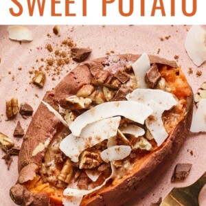 An overhead shot of a dessert sweet potato with topping sprinkled around. A gold fork rests on the plate next to the potato.