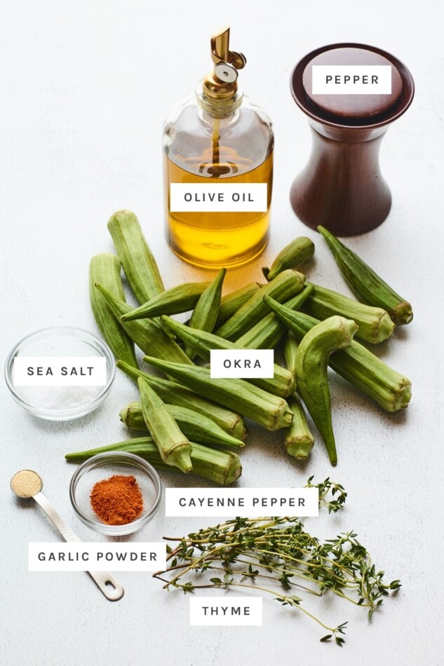 Pin this recipe for oven roasted okra for later! Ingredients measured out to make roasted okra: olive oil, pepper, salt, fresh okra, garlic powder, cayenne pepper and fresh thyme.