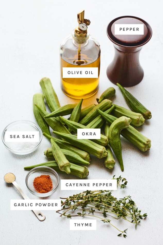 Ingredients measured out to make roasted okra: olive oil, pepper, salt, fresh okra, garlic powder, cayenne pepper and fresh thyme.