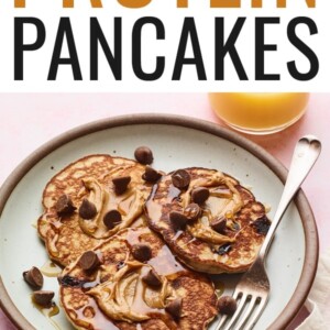 Plate of protein pancakes topped with chocolate chips, maple syrup and peanut butter.