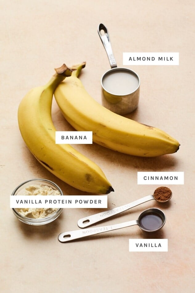 Ingredients measured out to make vanilla protein ice cream: almond milk, banana, cinnamon, protein powder and vanilla.