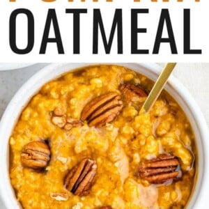 Bowl of pumpkin oatmeal topped with pecans and maple syrup.