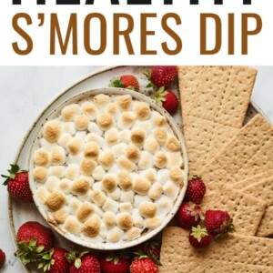 S'mores dip plated with strawberries and graham crackers for dipping.