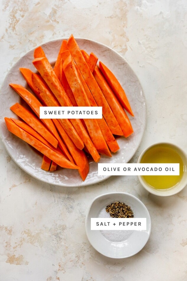 Ingredients measured out to make air fryer sweet potato fries: sweet potatoes cut into fry shape, olive oil, salt and pepper.
