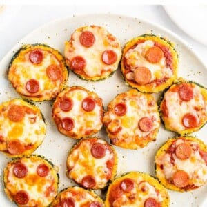 Zucchini pepperoni pizza bites on a plate.