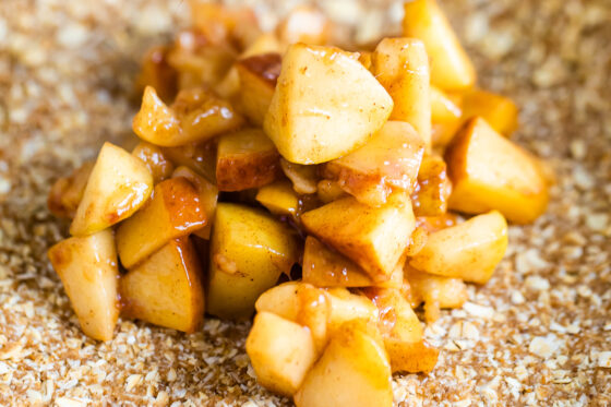 A close up shot of apple filling for apple crumble bars.