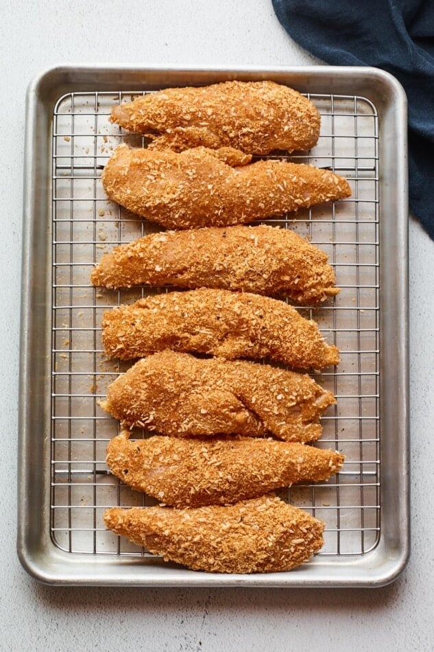 Overhead shot of chicken tenders on a baking sheet.