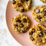 An overhead shot of 5 cookies on a plate.