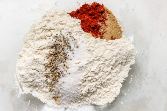 Flour, paprika, garlic powder, salt and pepper in a bowl.
