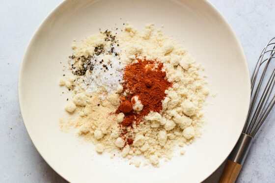 Dry ingredients in a bowl with a whisk.