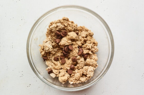 Peanut butter protein bar mixture with chocolate chips in a bowl.