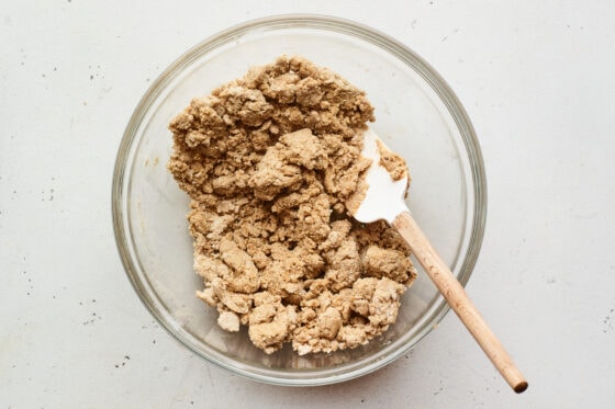 Spatula in a mixing bowl with peanut butter protein bar mixture.