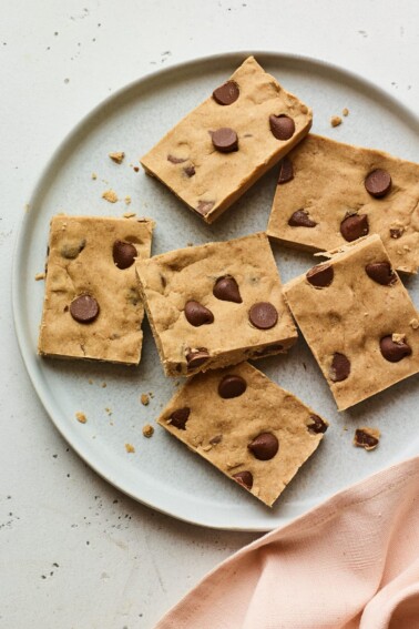 Chocolate chip peanut butter protein bars on a plate.