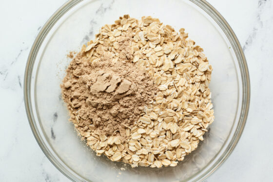 Mixing bowl with protein powder and oats.