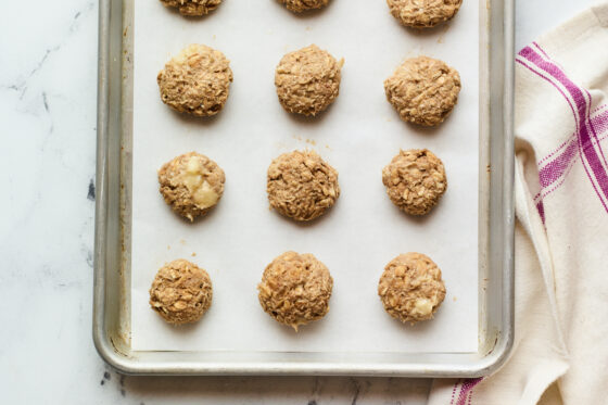 Cookie sheet lined with parchment and no bake protein cookies.