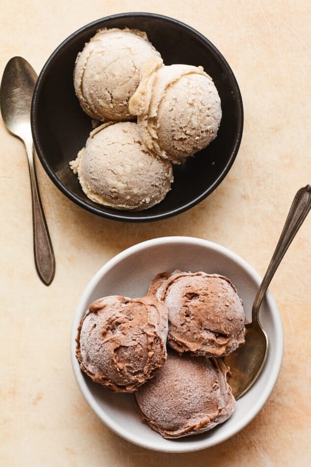 Two bowls. Each has three scoops of protein ice cream. One bowl has vanilla protein ice cream and one bowl has chocolate ice cream.