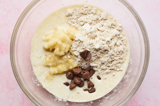 Pancake batter with mashed banana, oat flour and chocolate chips added before getting mixed in.