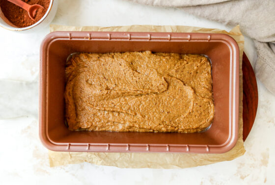 Batter for healthy pumpkin bread in a bread loaf pan, ready to be baked.